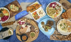 Middle Eastern Food and Drink for Takeout or Dine-in if Available at Holy Pita (Up to 30% Off)