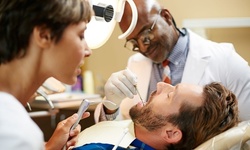 $1,300 towards Dental Implant with Tooth Cleaning and Teeth Whitening Treatment at Texas Dental Center (96% Off)
