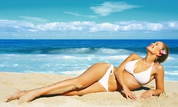 Three Spray Tans or One Month of Unlimited Tanning-Bed Sessions at Beverly Hills Tanning (Up to 73% Off)