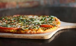 Wood-Fired Pizza and Iron-Skillet Pasta from Red Tomato Pizza (Up to 52% Off). Six Options Available.